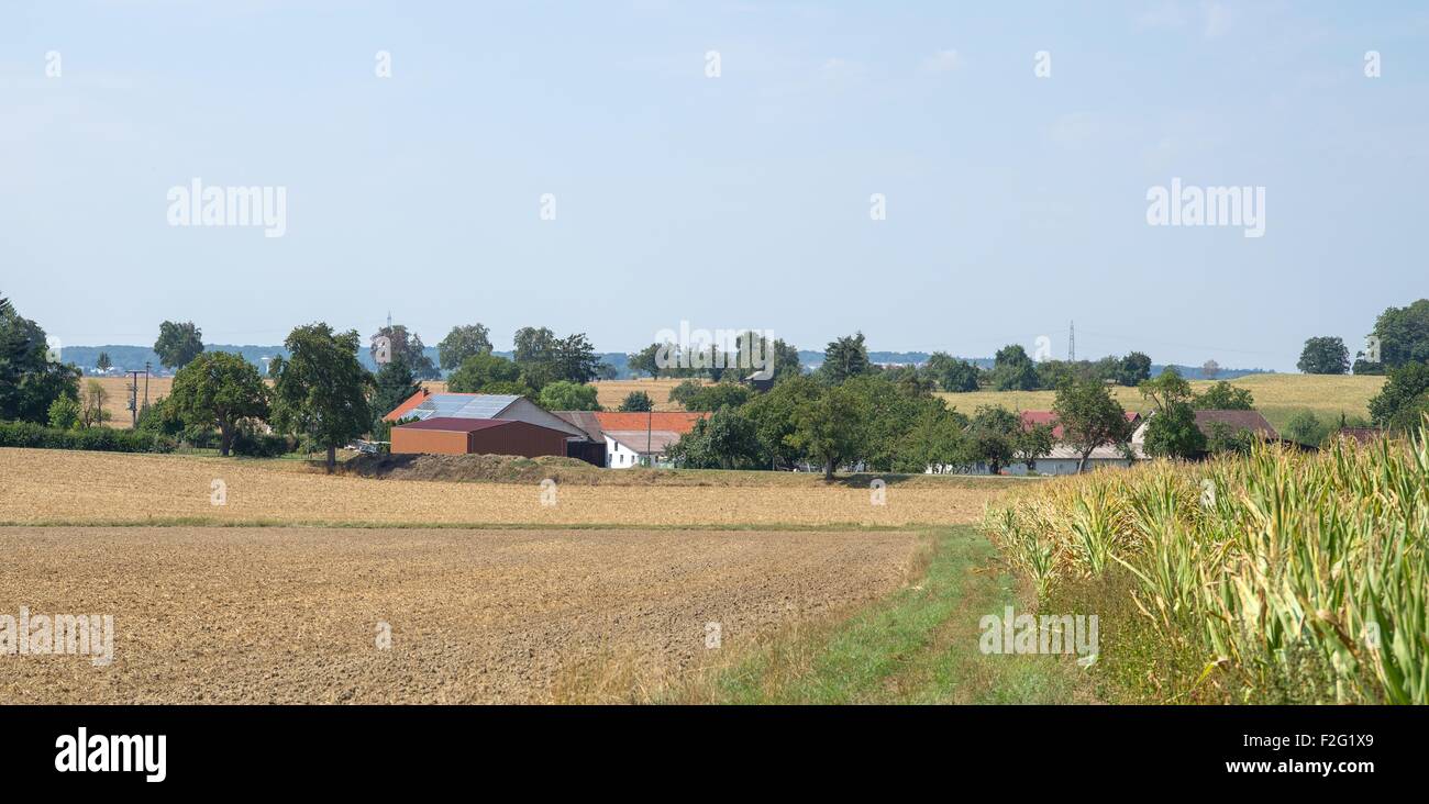 rural scenery including a small village in sunny ambiance at summer time Stock Photo