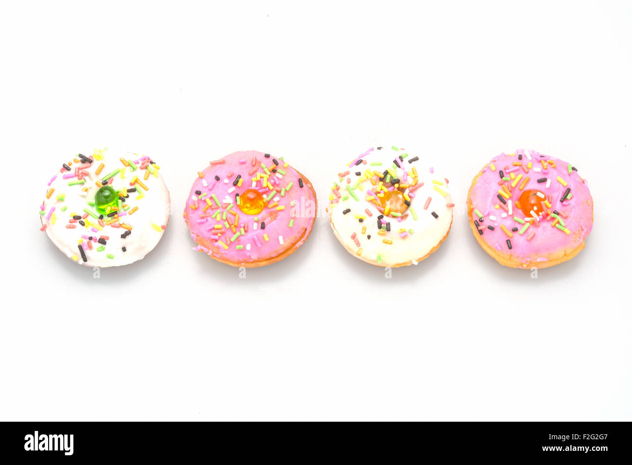 Fresh homemade colorful donuts with icing glaze delicious on white background Stock Photo