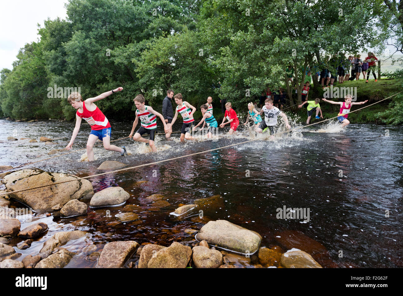 Fording a stream on the the junior fell race, Muker Show, North Yorkshire, 2015 Stock Photo
