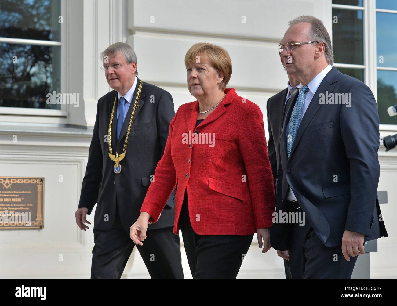 Halle, Germany. 18th Sep, 2015. German Chancellor (CDU) Angela Merkel arrives for the annual meeting of the Leopoldina German National Academy for Sciences with the Premier of Saxony-Anhalt, Reiner Haseloff (CDU, R) and the President of the Leopoldina Joerg Hacker in Halle, Germany, 18 September 2015. The event this year is being held under the title 'Symmetry and asymmetry in science and art' Photo: HENDRIK SCHMIDT/DPA/Alamy Live News Stock Photo