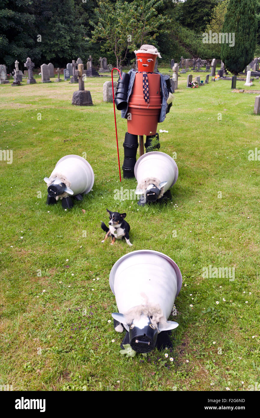 Flowerpot shepherd and sheep in the churchyard, Settle Flowerpots Festival, Settle, North Yorkshire, 2015 Stock Photo