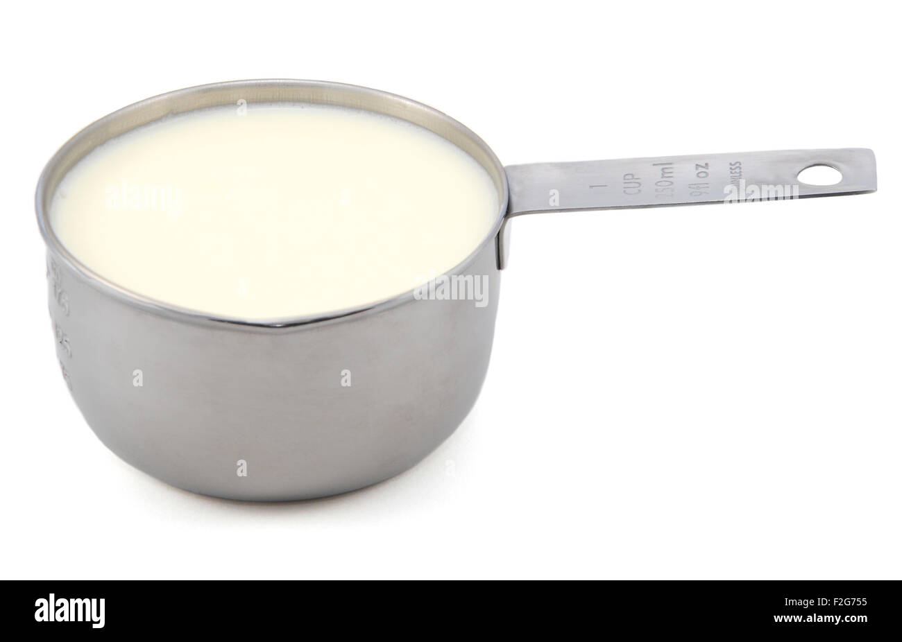 Milk in an American measuring cup, isolated on a white background Stock Photo Alamy