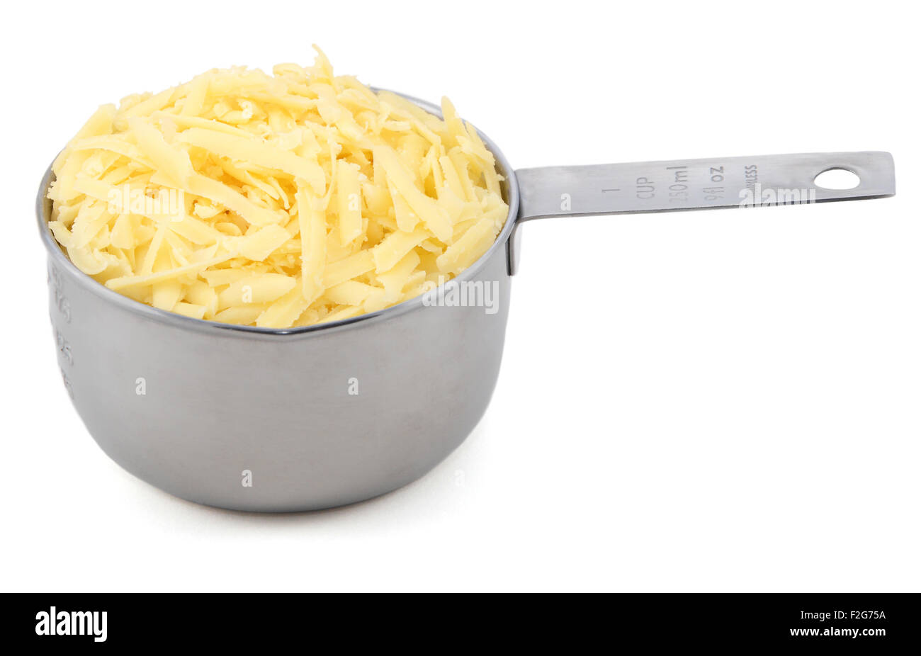 Grated cheese in an American measuring cup, isolated on a white background Stock Photo