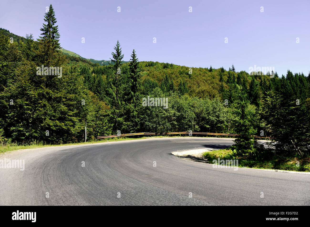 A hairpin turn on an empty mountain road Stock Photo