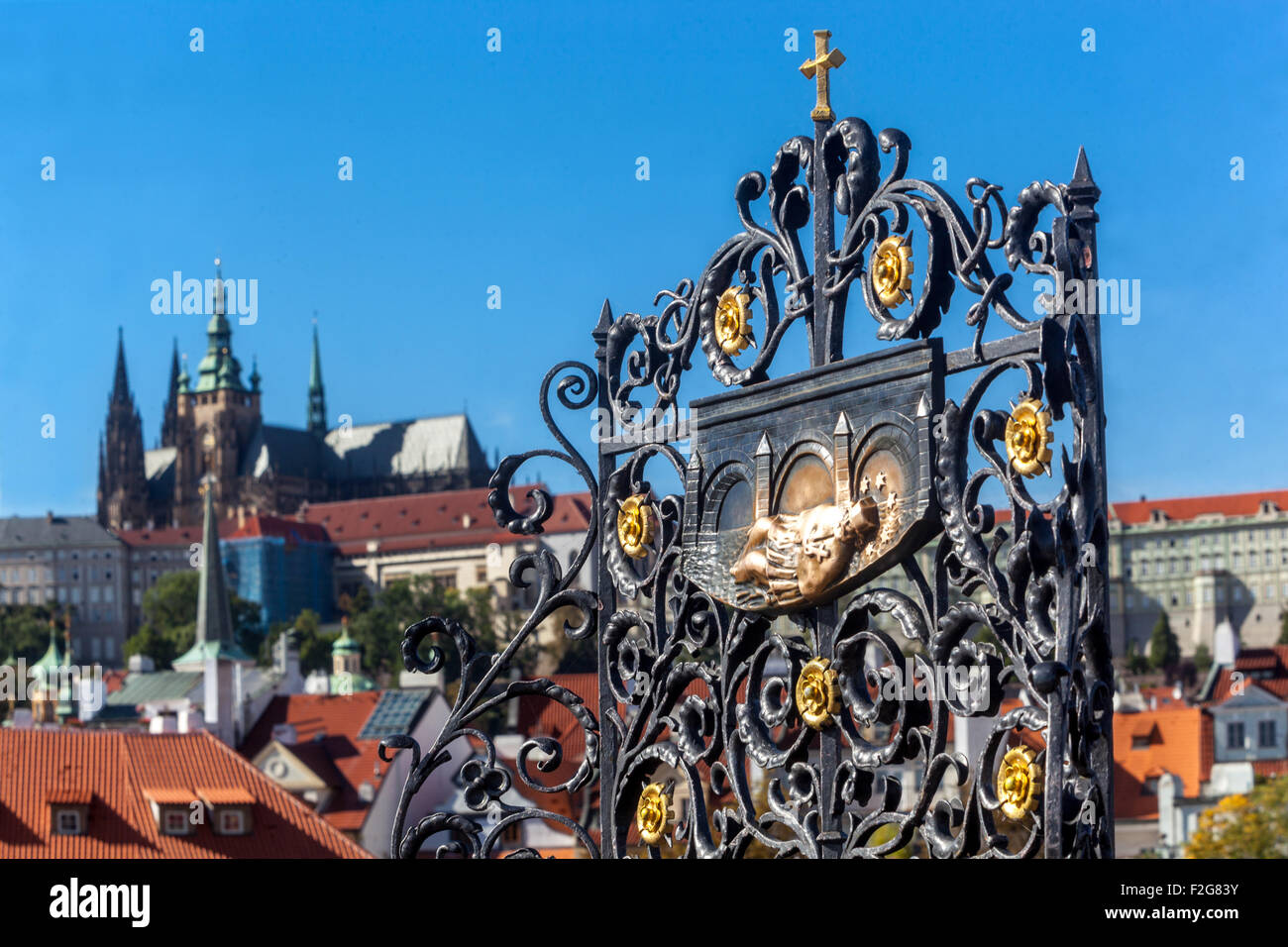 The iron grille and relief, the place where according to legend was thrown into the Vltava river St John of Nepomuk Prague Charles Bridge Czech Republic Stock Photo