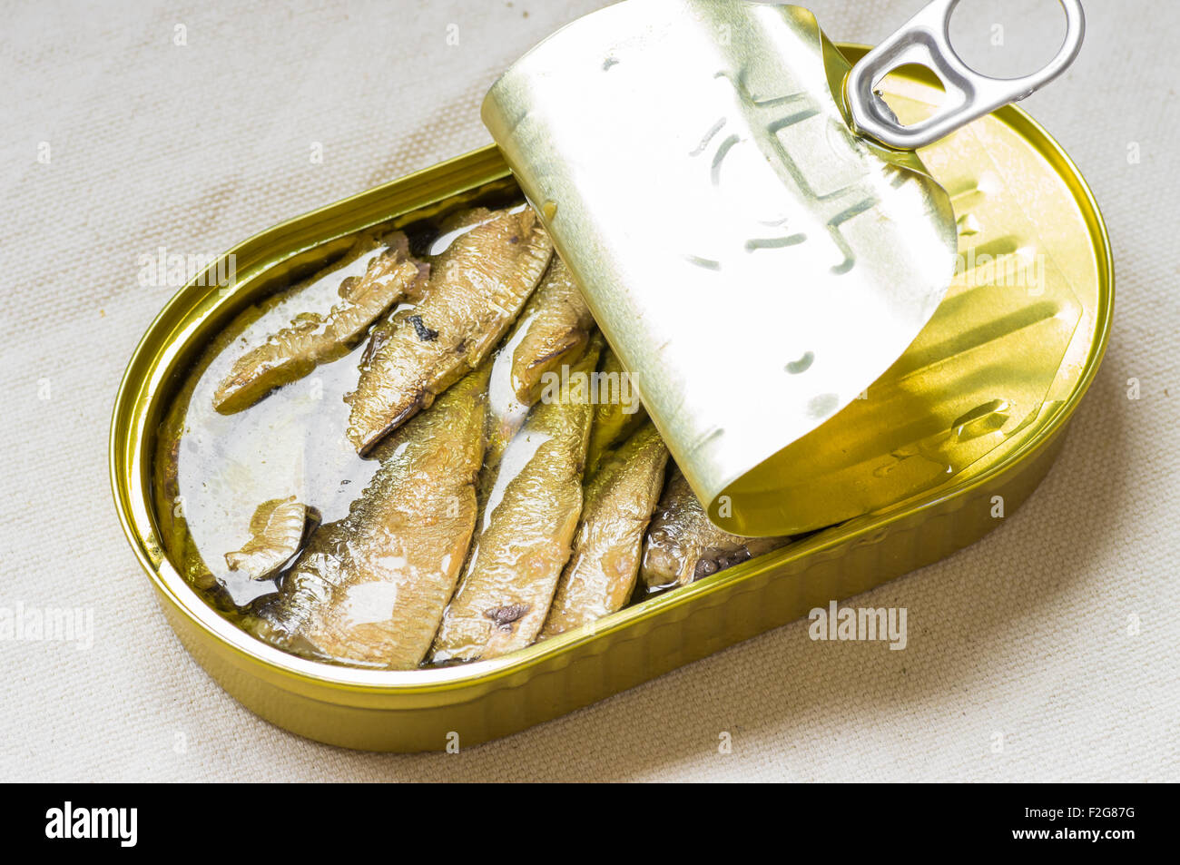 Tasty fish canned sardines in a tin on the table Stock Photo - Alamy