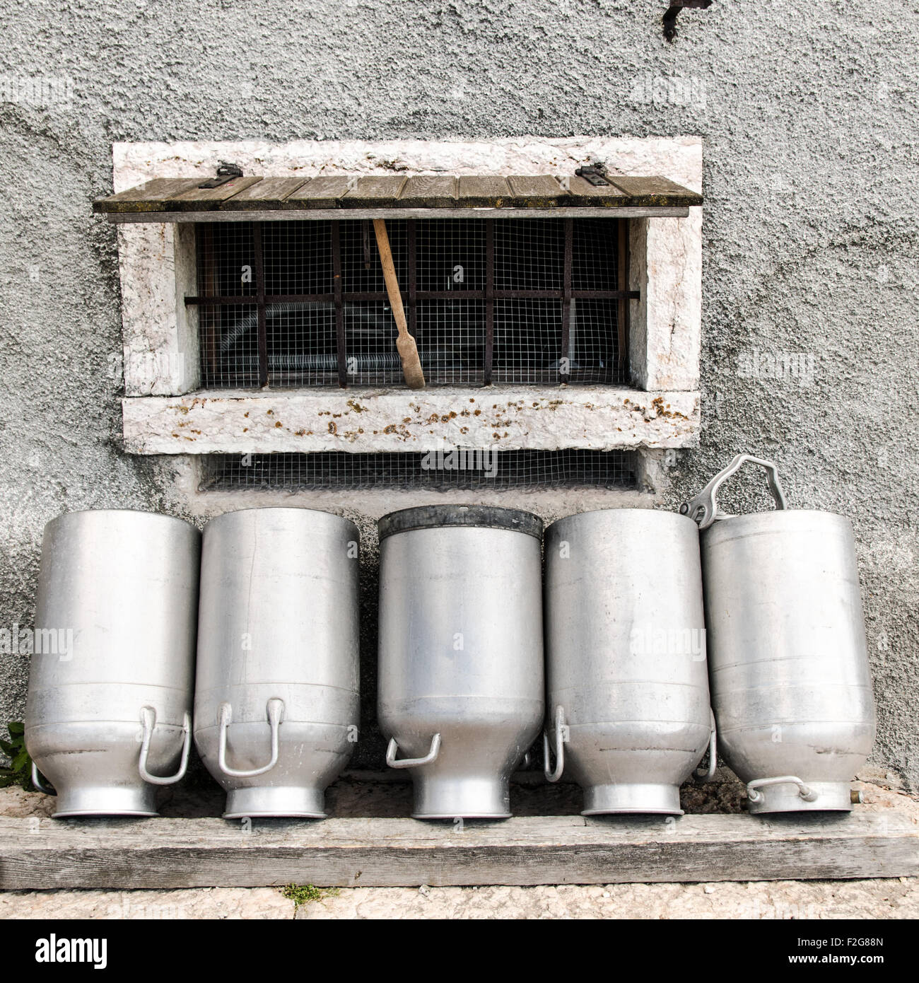 Vintage milk cans in rural Northern Italy. Stock Photo