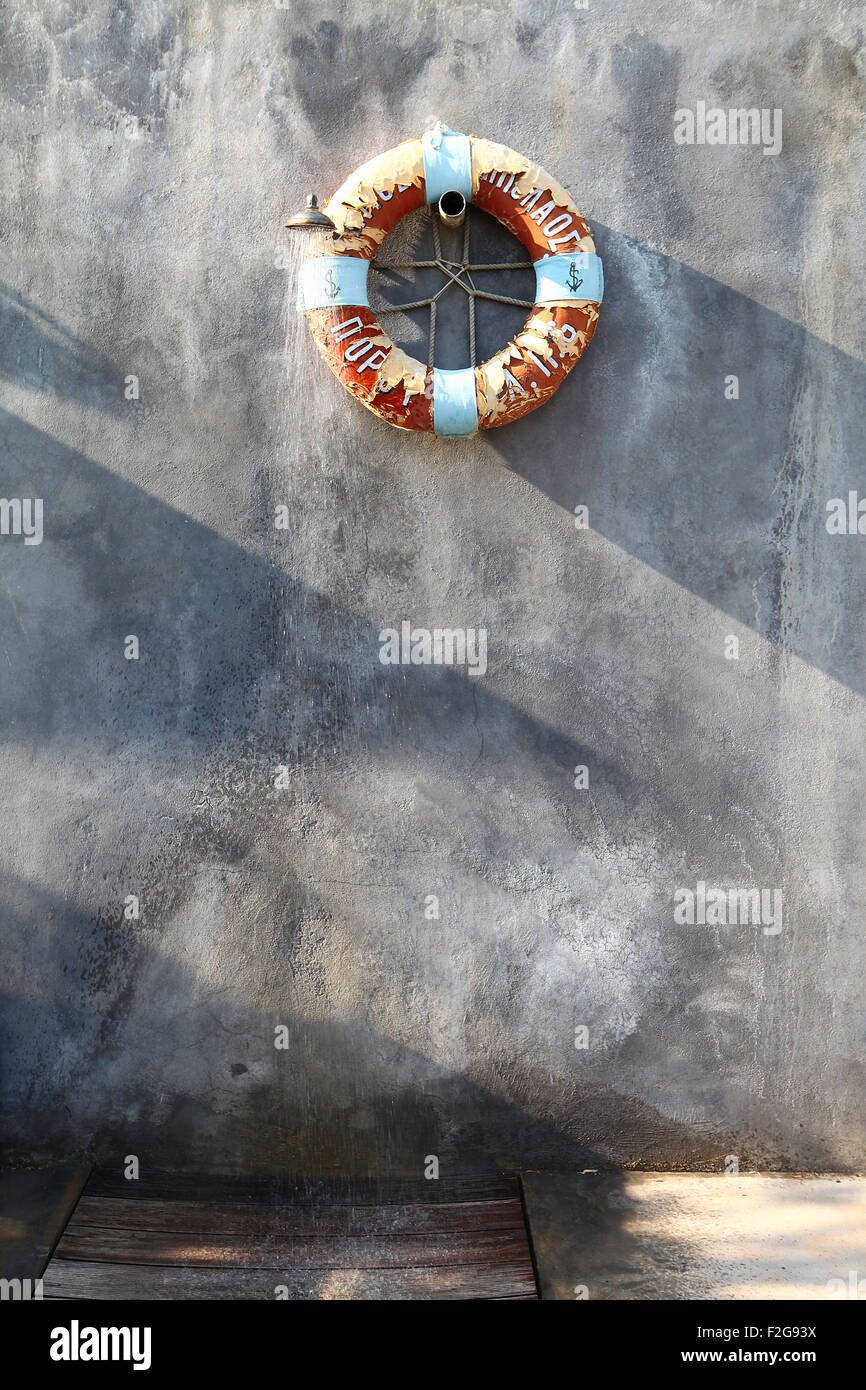 Lifesaver hanging on stone wall Stock Photo Alamy