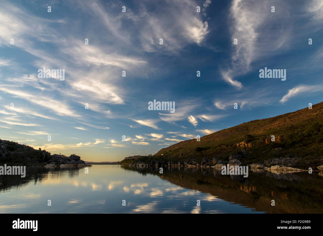 Blue sky and white clouds over lake Stock Photo - Alamy