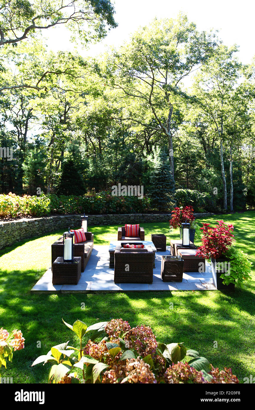 Seating area in large garden with rattan furniture Stock Photo
