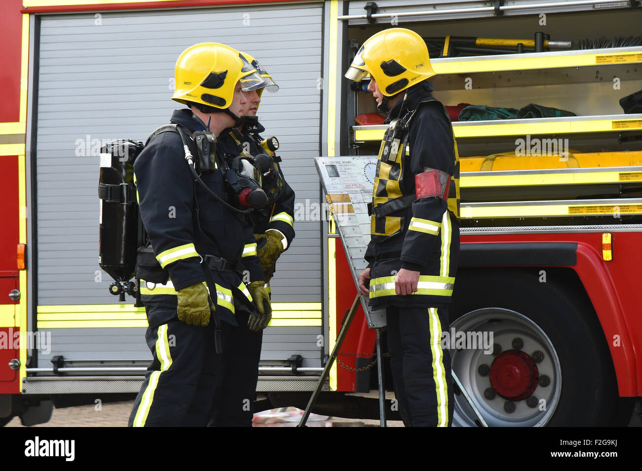 Firefighters in breathing apparatus BA BASCA are briefed before entering fire Stock Photo