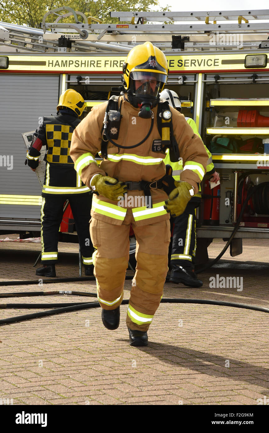 Firefighter in breathing apparatus on the move, blurred movement of subject. Stock Photo
