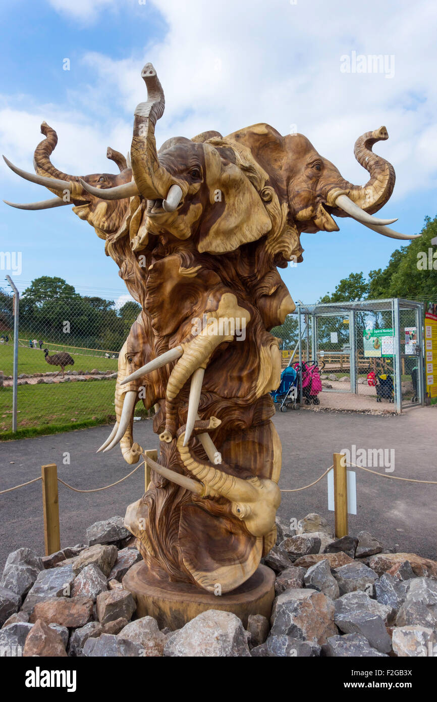 A hardwood sculpture of Elephants Heads at Dalton Zoo Cumbria UK Stock Photo