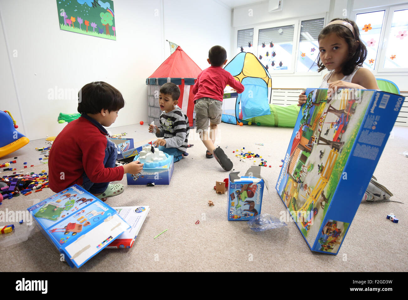 Refugee children play a media event in the  kindergarten of a centralised initial processing station (ZEA) for refugees in Hamburg, Germany 18 September 2015. The  children are part of the 'Aktion Zusammenspiel - Buendnisse für junge Fluechtlinge' (lt: Play Together Campaign - Alliances for Refugee children). The focus of the Germany-wide campaign is interaction between refugee children and German children. Photo: Christian Charisius/dpa Stock Photo