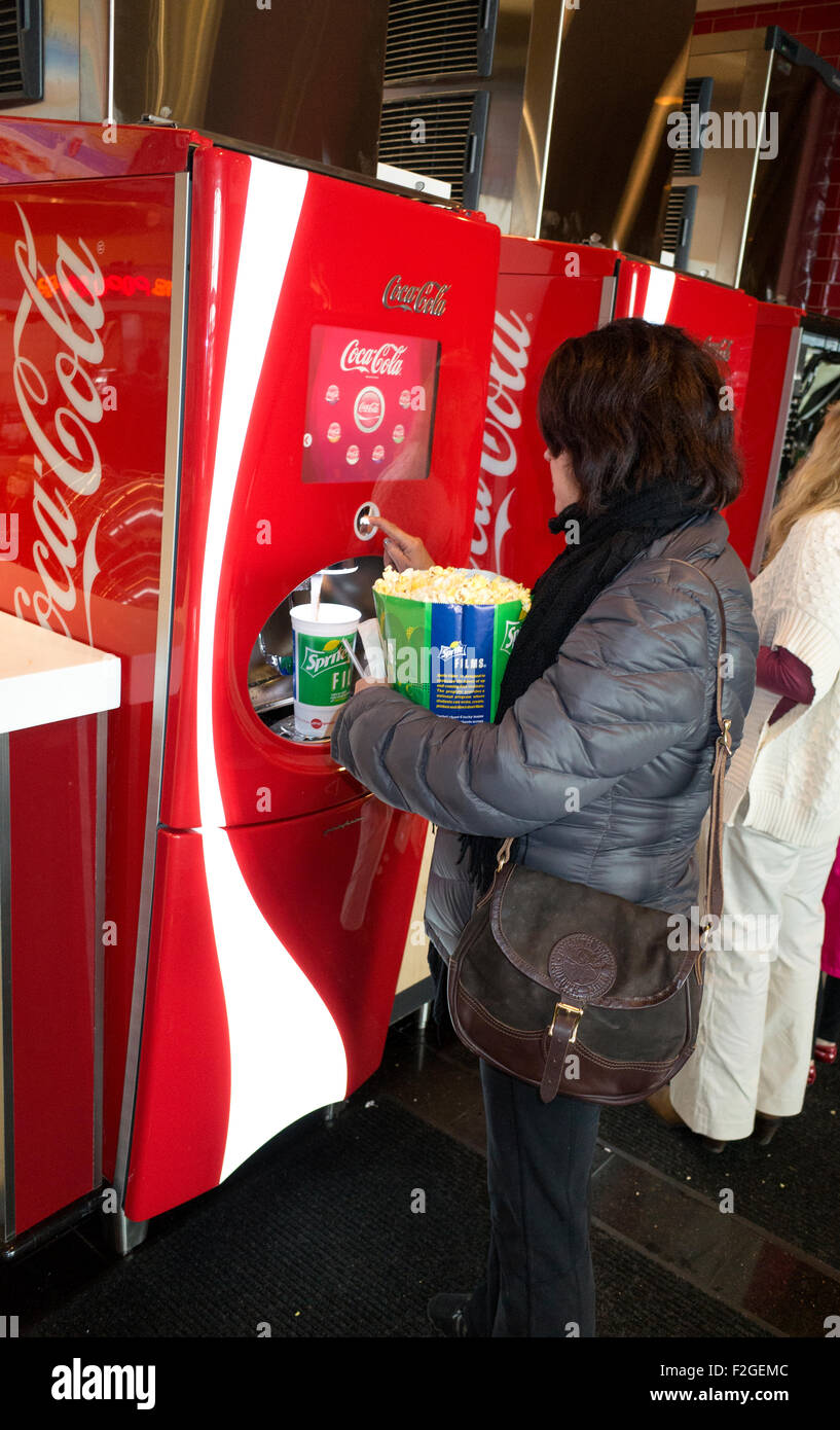 Dispensing a coke from the self-service beverage machine at the AMC movie theater.  Roseville Minnesota MN USA Stock Photo