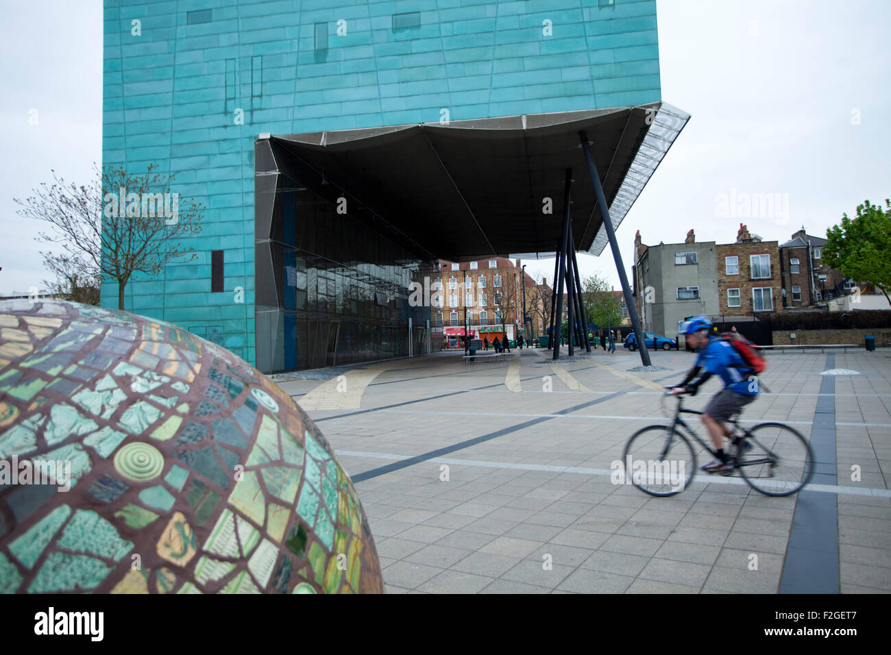 A view of Peckham Square with Peckham library and a cyclist. Stock Photo