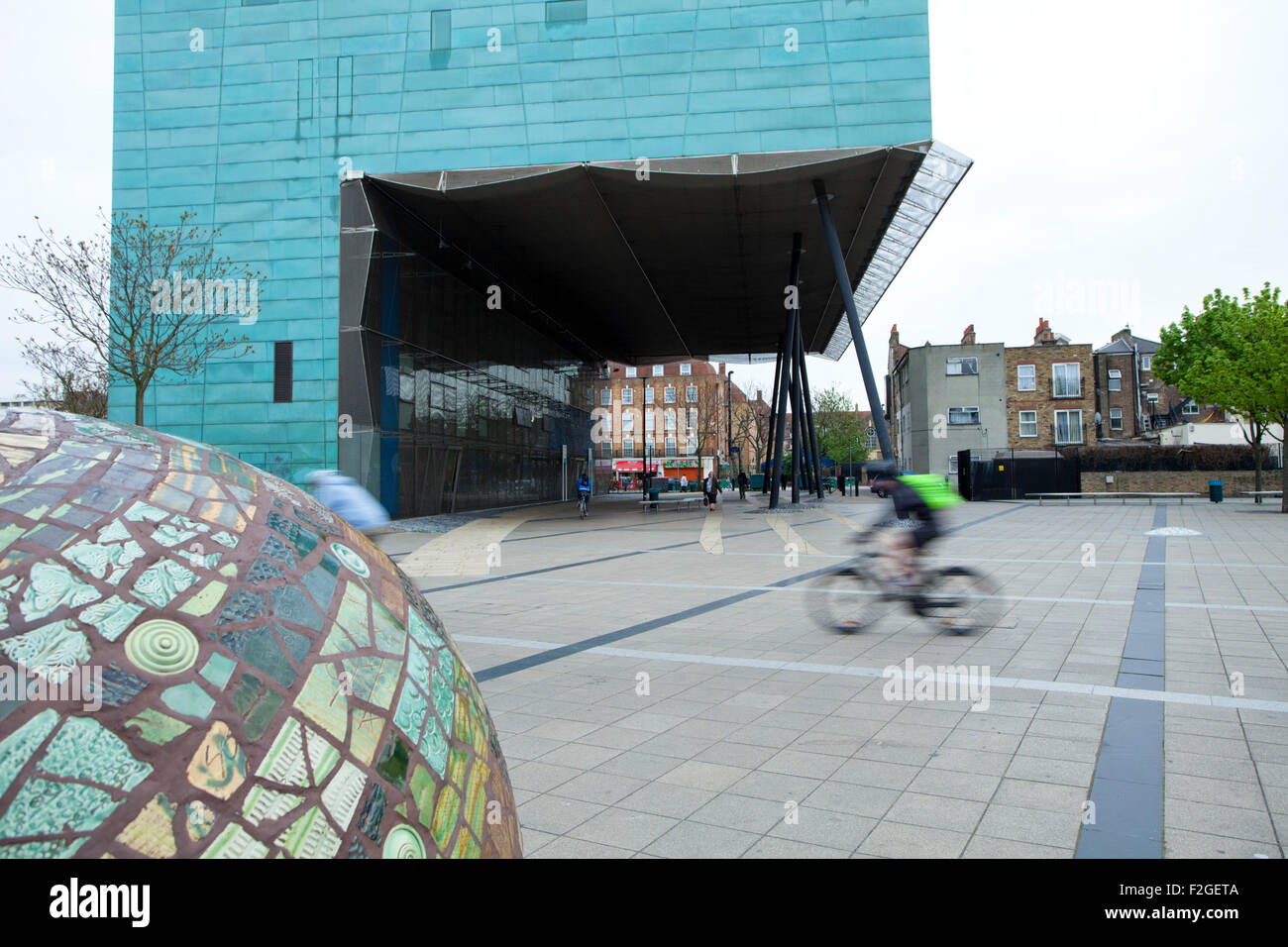 A view of Peckham Square with Peckham library and a cyclist. Stock Photo