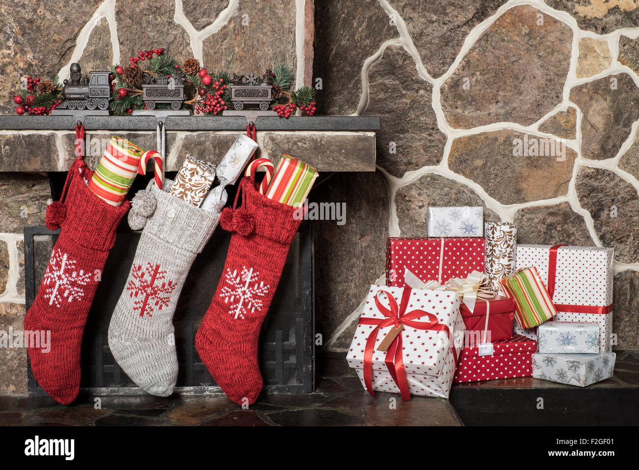 Stuffed stockings hanging on a fireplace on christmas morning Stock Photo