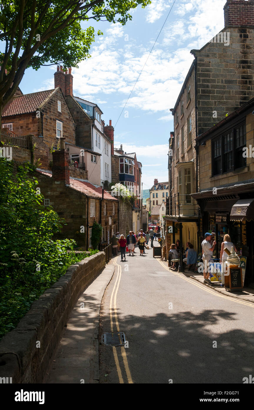 Houses built on a steep slope, and shops, on New Road, Robin Hood's Bay