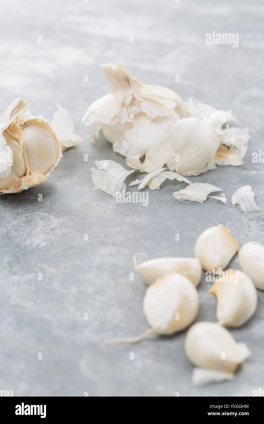 Garlic bulb and single cloves on a cold modern metal background Stock Photo