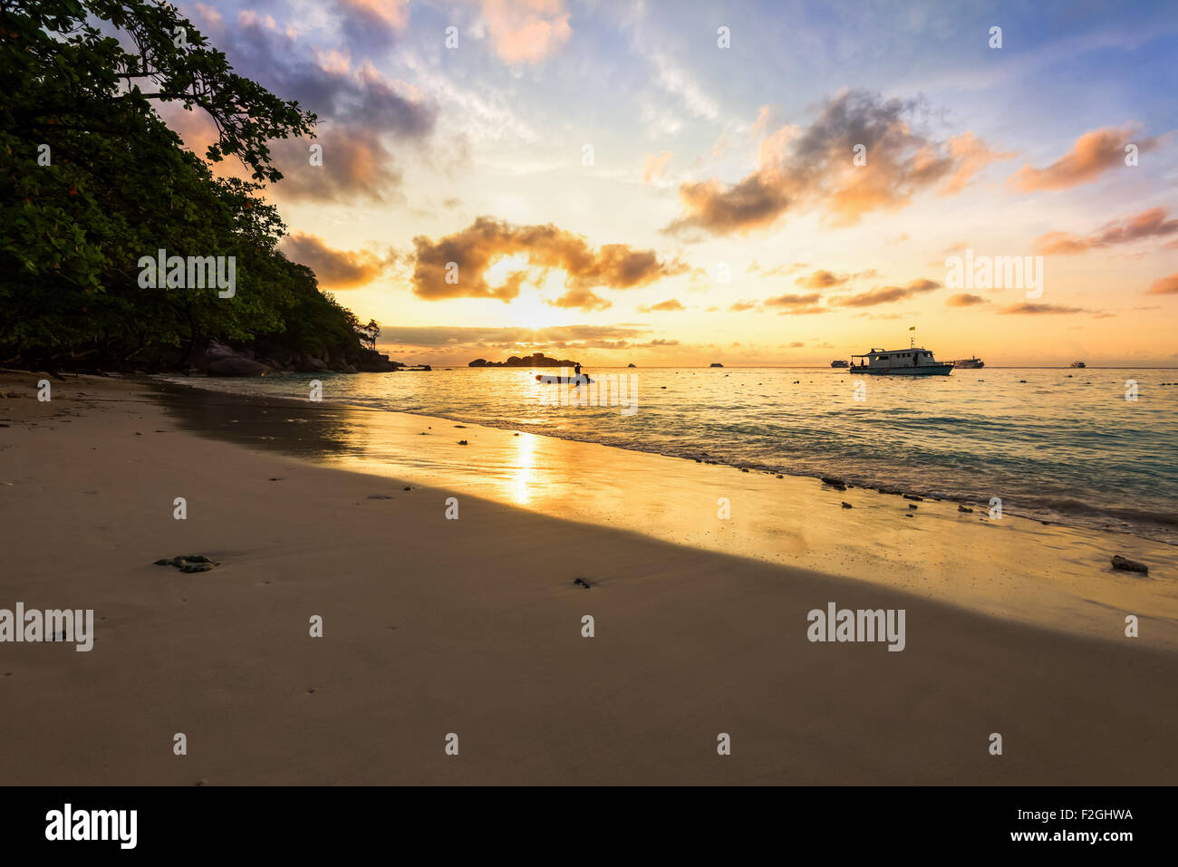 Beautiful landscapes of golden light the sky over the beach and sea during sunrise on Koh Miang Islands, Mu Koh Similan Stock Photo