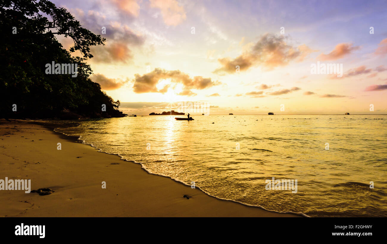 Beautiful landscapes of golden light the sky over the beach and sea during sunrise on Koh Miang Islands, Mu Ko Similan Stock Photo