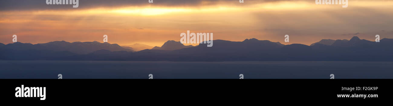 A view at sunrise from the Quiraing over towards the distant Torridon hills on the Scottish mainland. Stock Photo