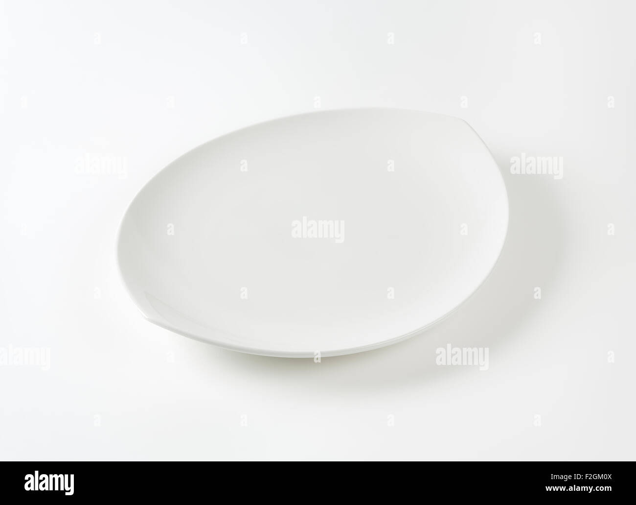 Oval white porcelain plate with pointed ends Stock Photo Alamy