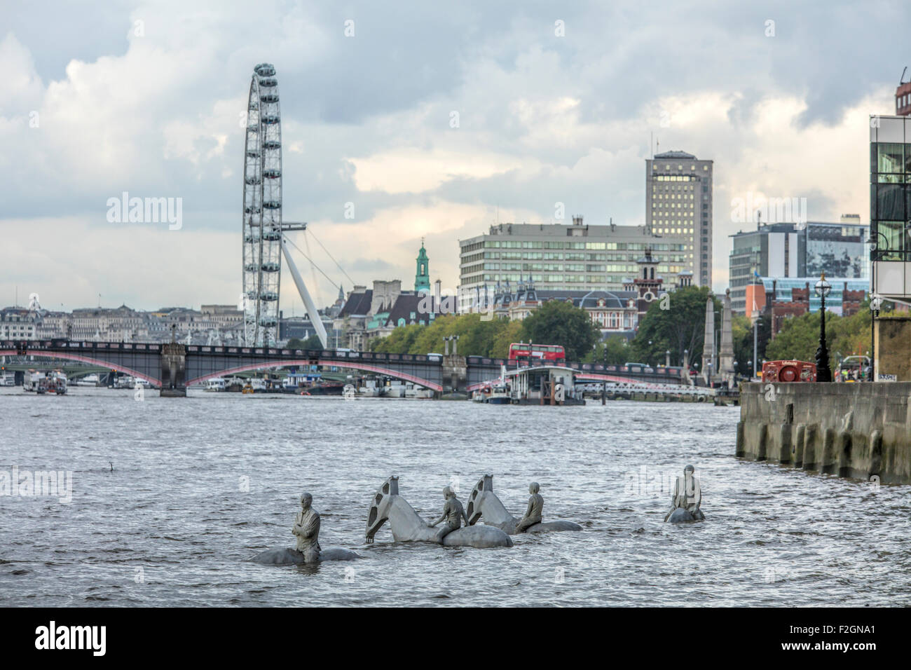 White horses in the River Thames at high tide with Lambeth Bridge and the London Eye in the distance. Stock Photo
