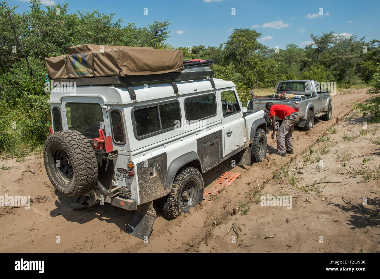 Auto mechanic working on broken down Land Rover in Botswana, Africa Stock Photo