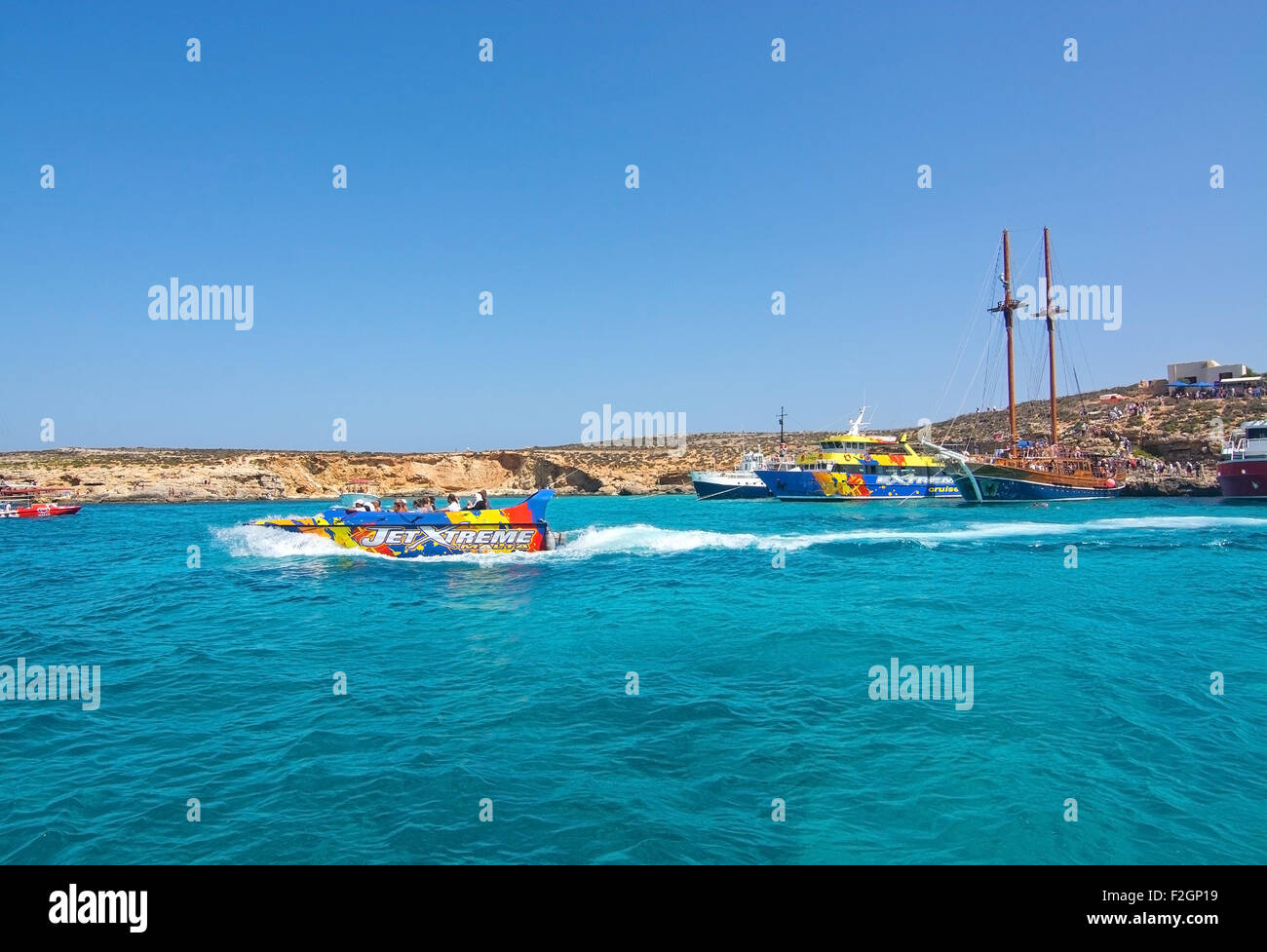 Tour boats in the clear turquoise water of Blue Lagoon on a sunny day in September. Stock Photo