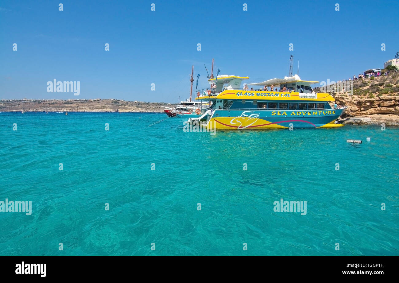Tour boats moor in the clear turquoise water of Blue Lagoon on a sunny day in September. Stock Photo