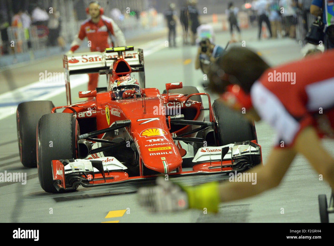 Singapore. 18th Sep, 2015. Team Ferrari driver Kimi Raikkonen drives in to the garage the second practice during F1 Singapore Grand Prix Night Race in Singapore's Marina Bay Street Circuit, Sept. 18, 2015. © Then Chih Wey/Xinhua/Alamy Live News Stock Photo