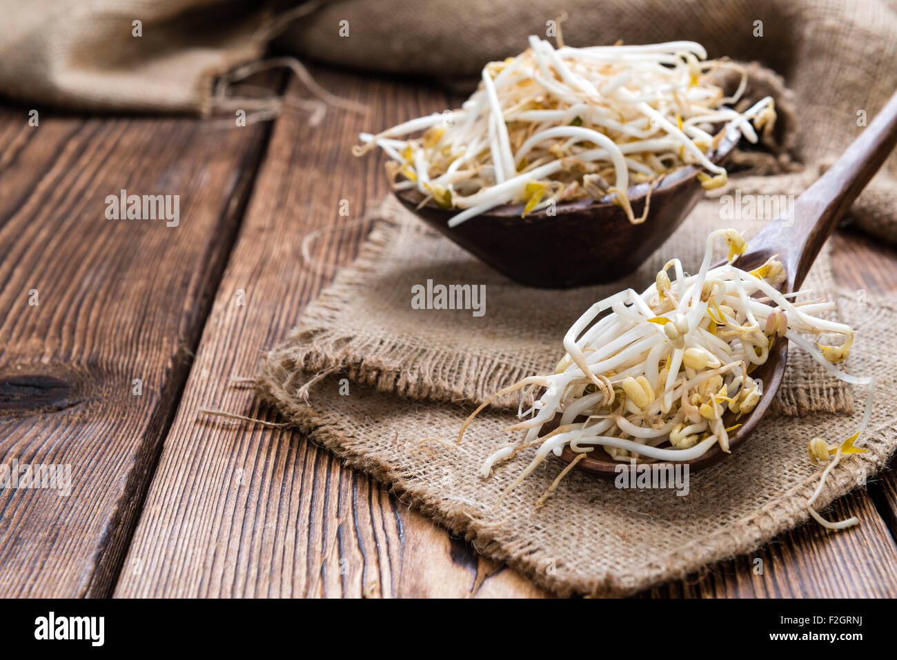 Bowl with Mungbean Sprouts on wooden background Stock Photo