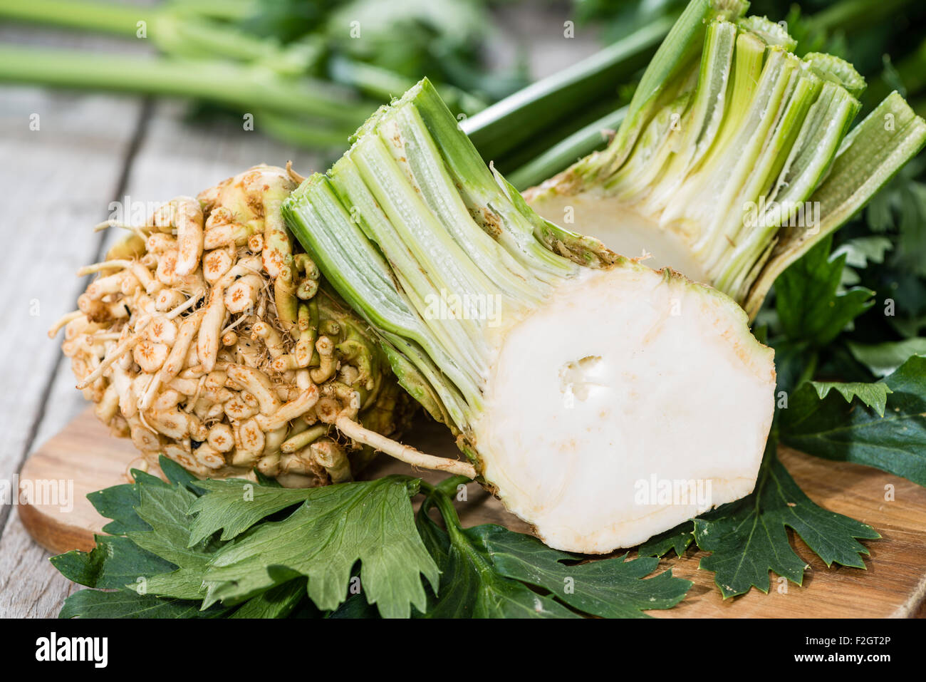 Portion of fresh Celeriac on wooden background (detailed close-up shot) Stock Photo