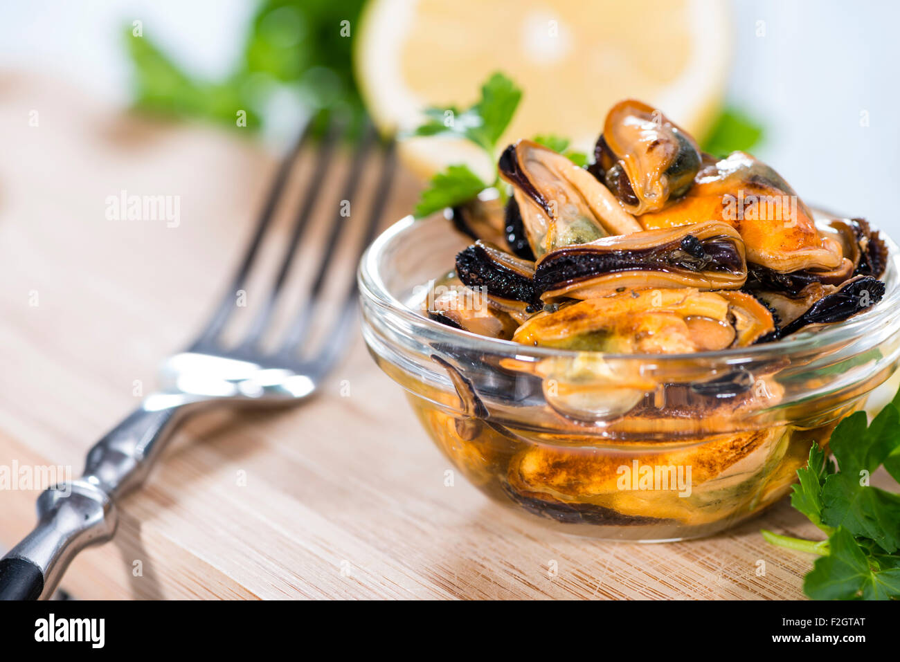 Some grilled Mussels with fresh herbs pickled on oil Stock Photo Alamy