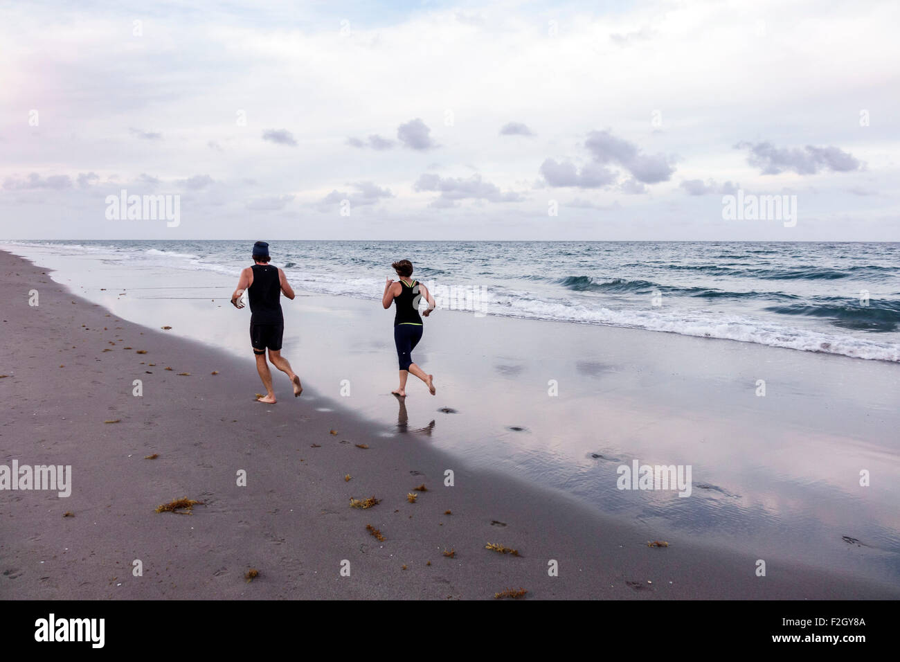 Delray Beach Florida,Atlantic Ocean,shore,surf,sand,man men male,woman female women,couple,jogging,running,FL150413067 Stock Photo