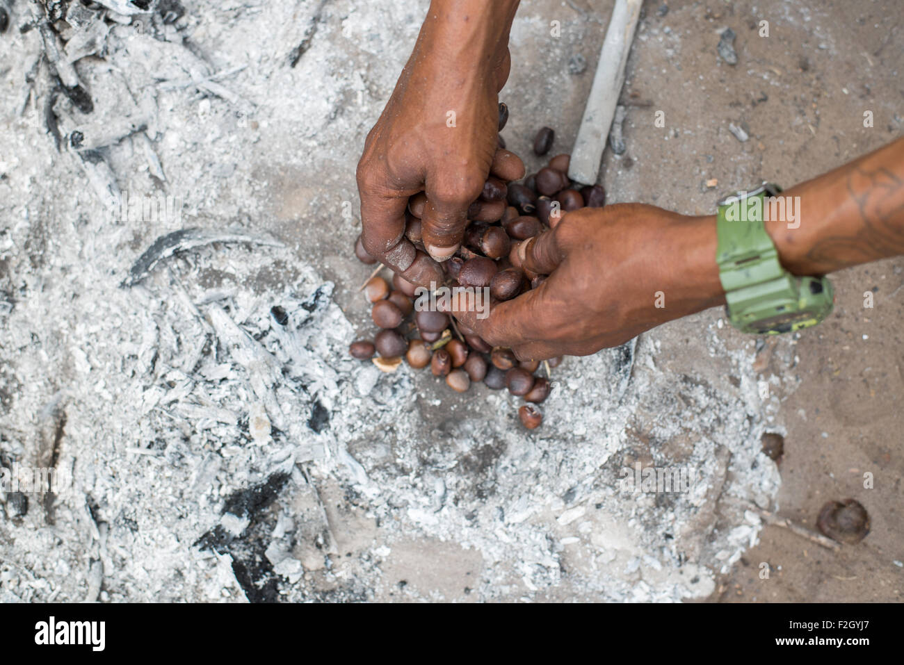 Bushmen or San people preparing food in Botswana, Africa Stock Photo