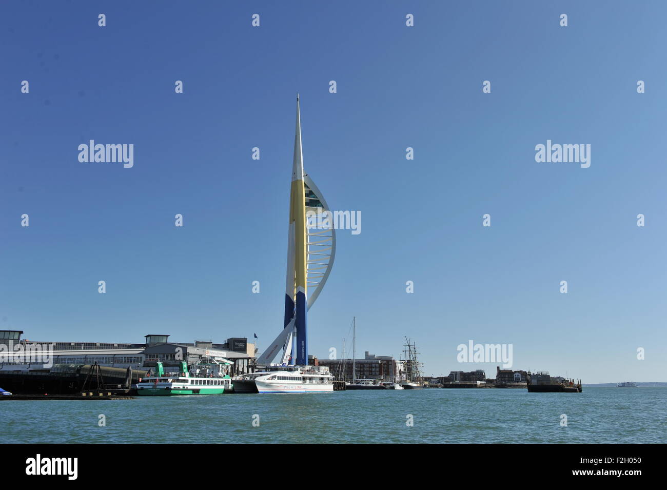 Portsmouth Hampshire UK - View of the Emirates Spinnaker Tower being painted in gold blue and white on quay side Stock Photo
