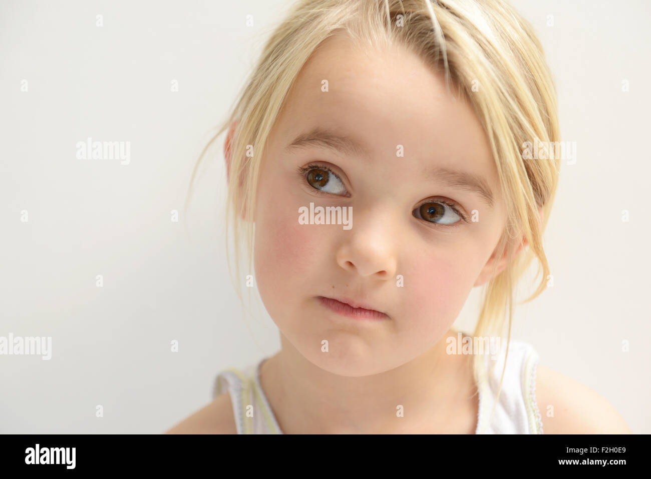 young girl looking at someone to the right Stock Photo