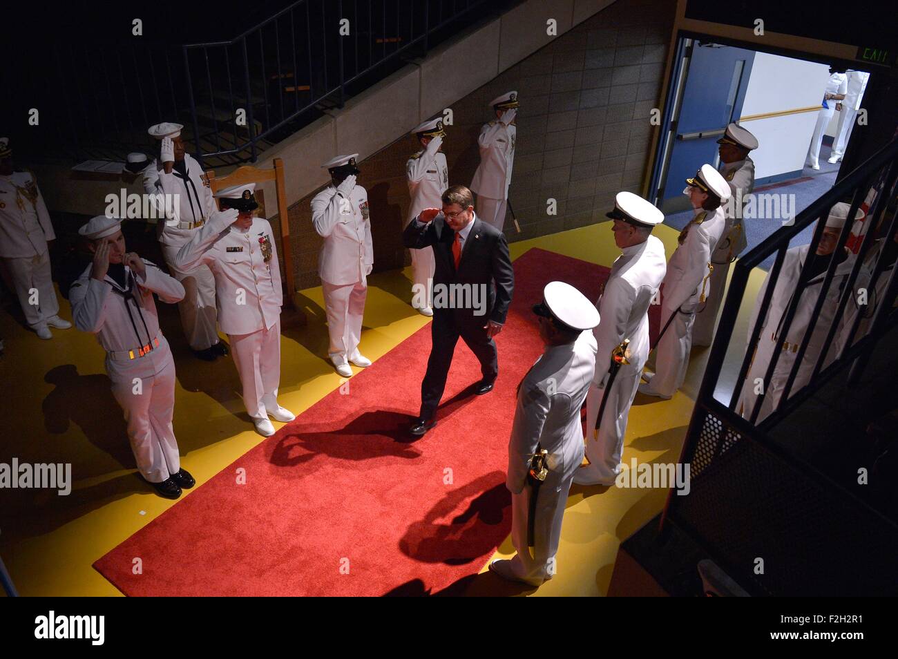 U.S. Defense Secretary Ashton Carter salutes as he walks past sideboys on arrival for a change of command ceremony between Adm. Jonathan Greenert, Chief of Naval Operations, and Adm. John Richardson at the U.S. Naval Academy September 18, 2015 in Annapolis, Maryland. Stock Photo