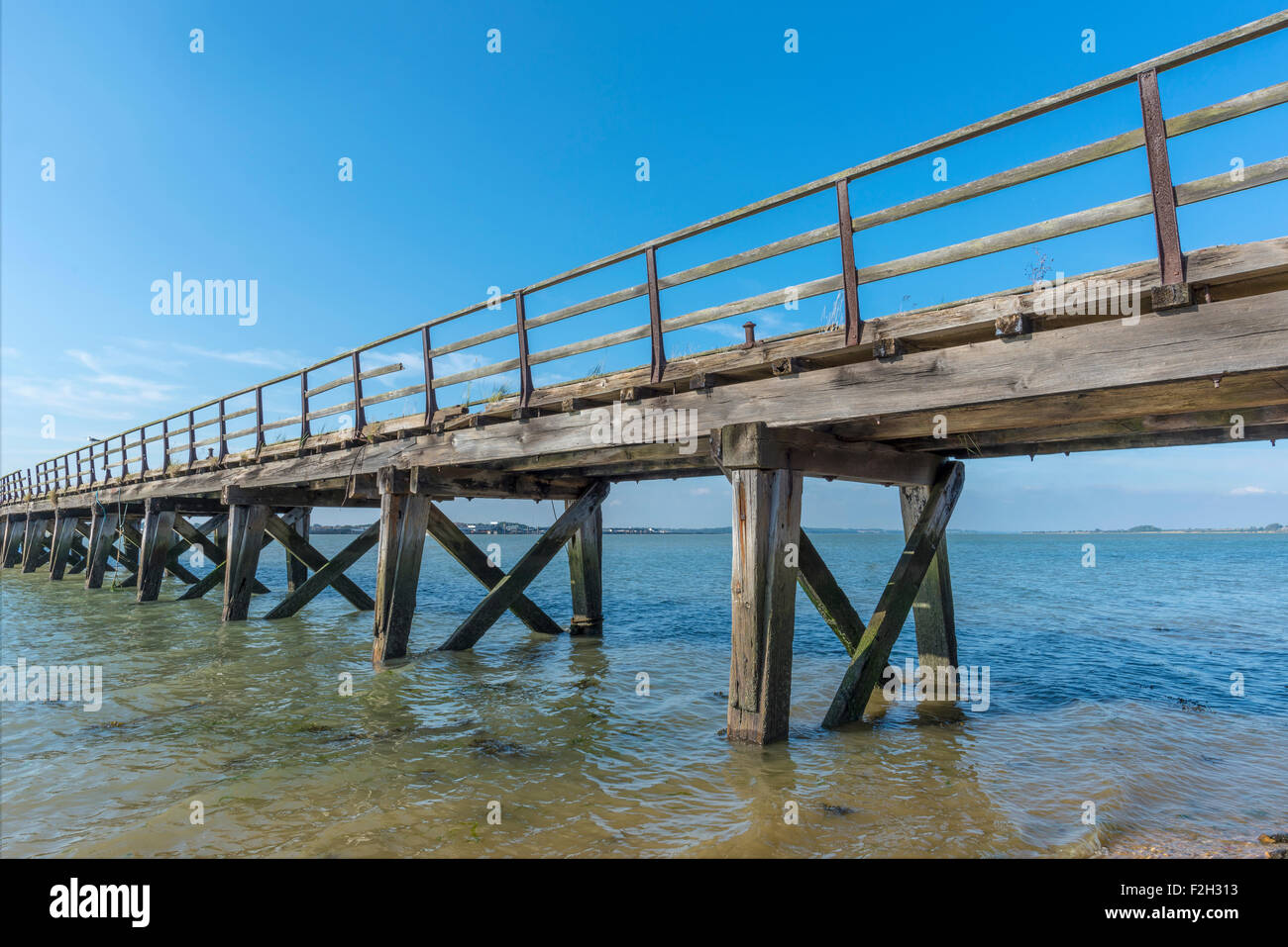 Old weathered wooden jetty on the seafront Stock Photo