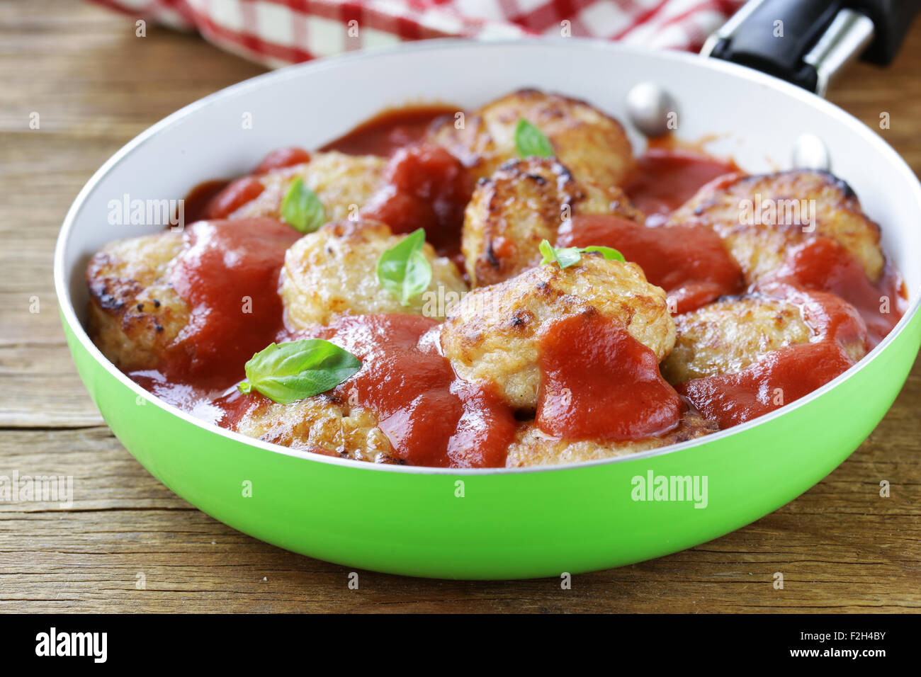 fried small meatballs in tomato sauce with basil Stock Photo Alamy