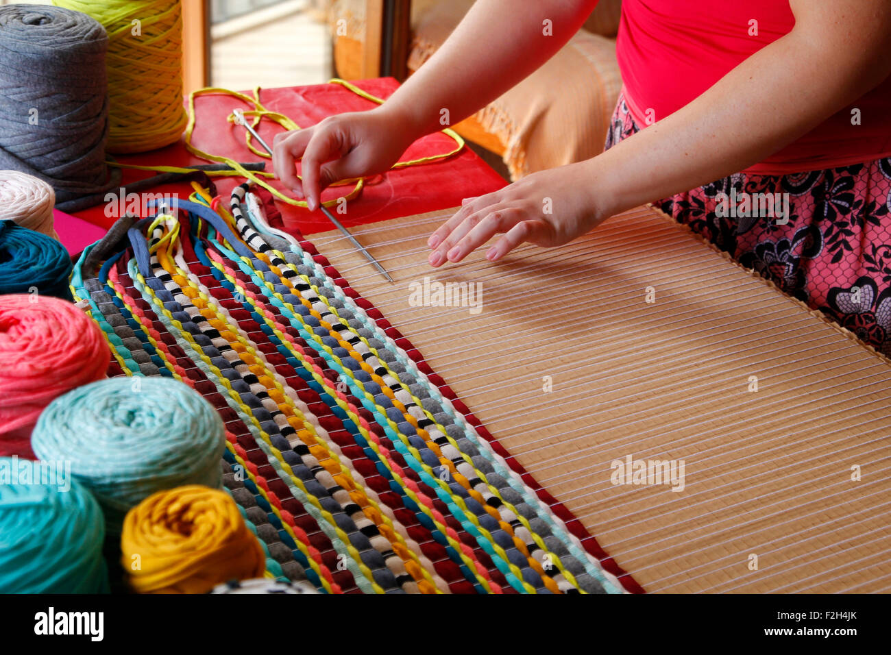 Woman hands weaving a handmade carpet Stock Photo Alamy