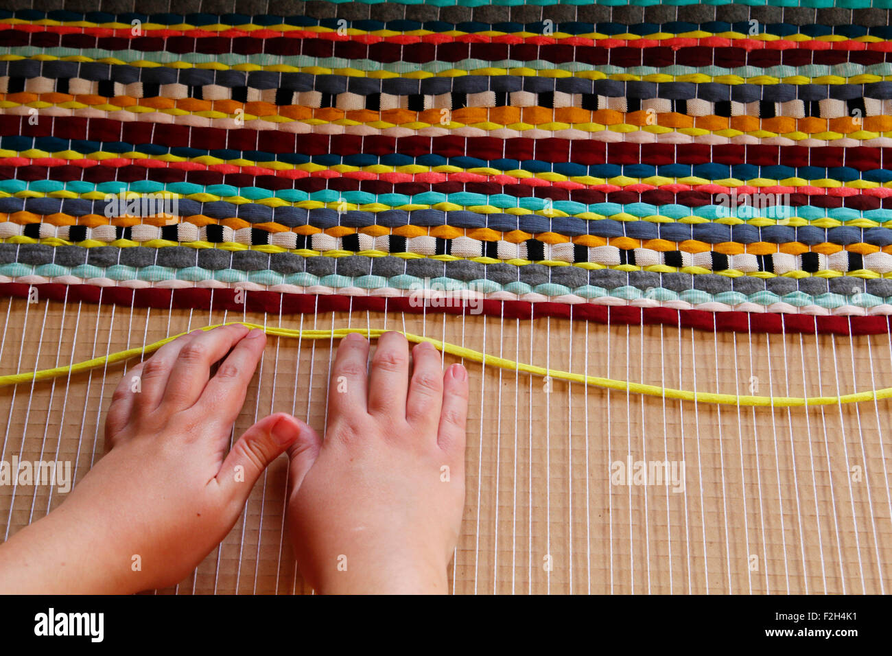 Woman hands weaving a handmade carpet Stock Photo - Alamy