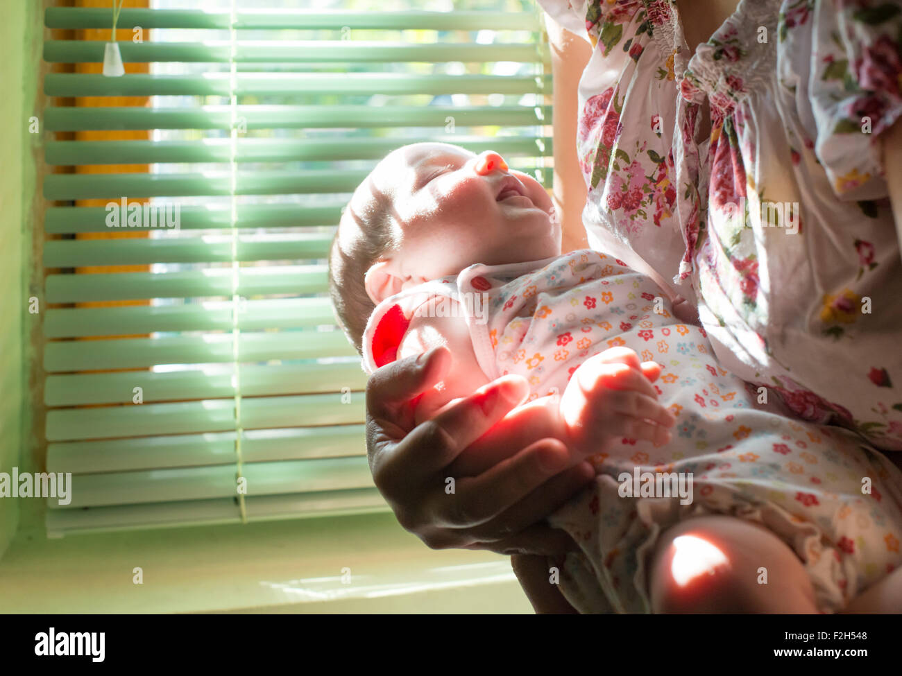 Baby and mom to the window. Backlight Stock Photo - Alamy