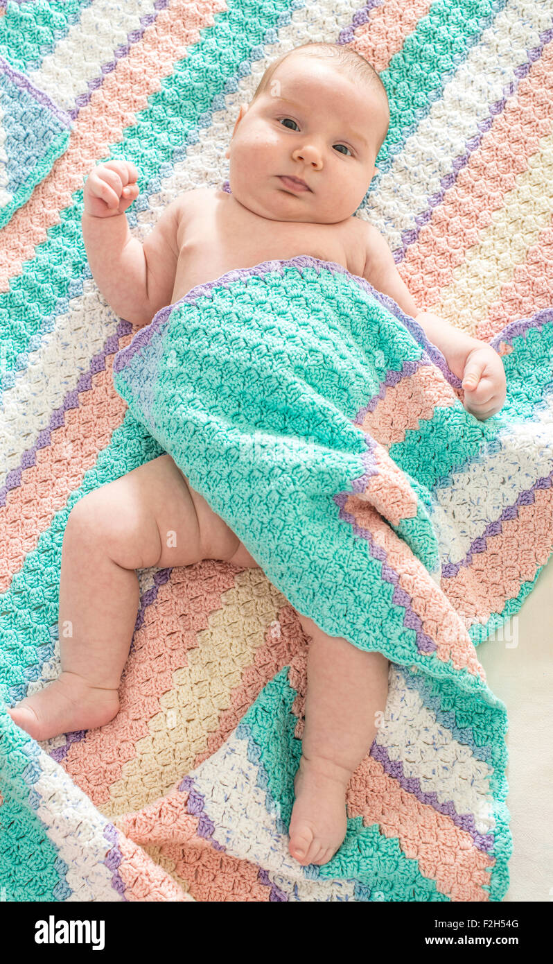 Baby in a baby bed. White clothes. Window light Stock Photo Alamy