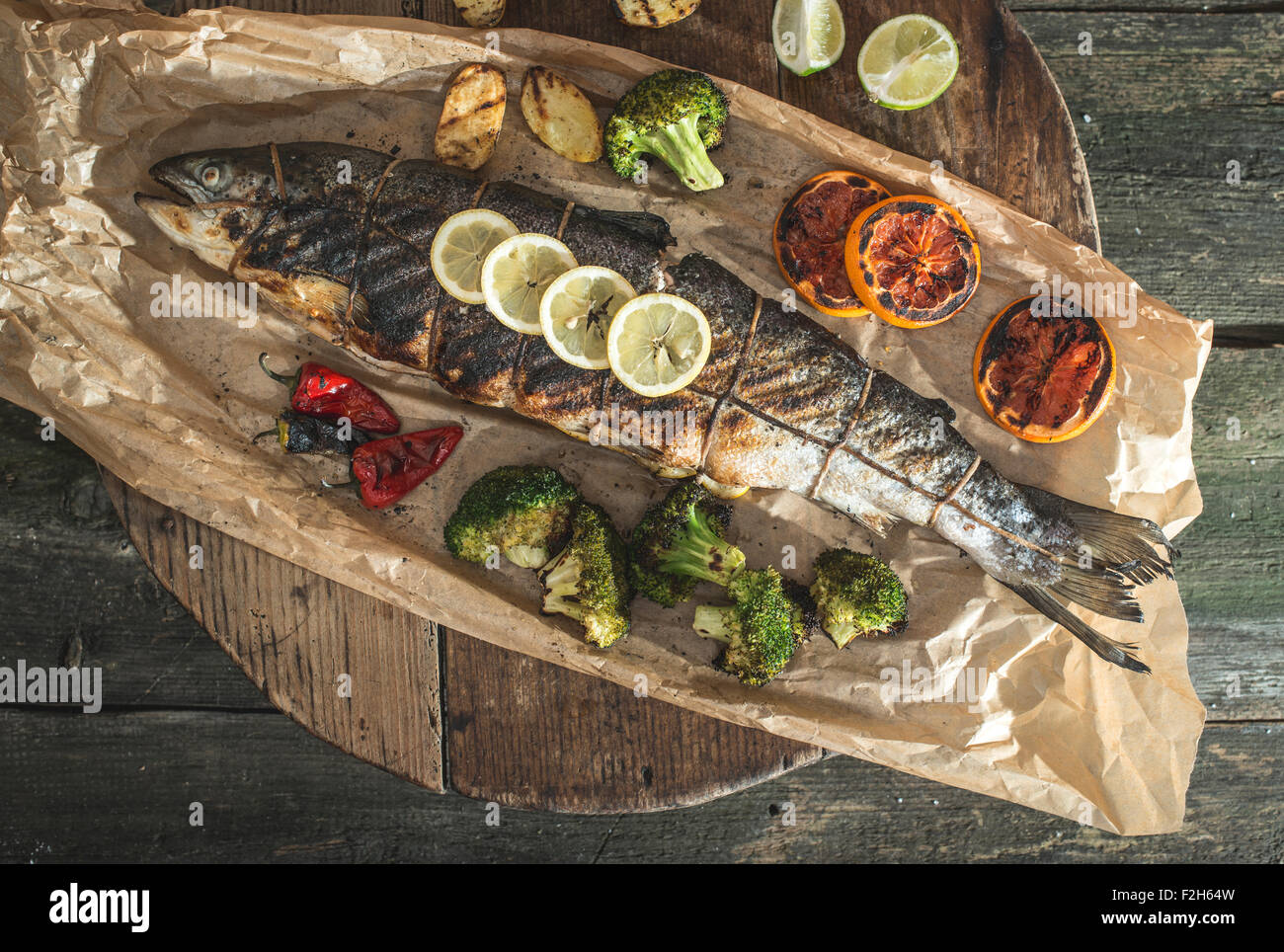 Roasted salmon and vegetables on vintage wooden table Stock Photo