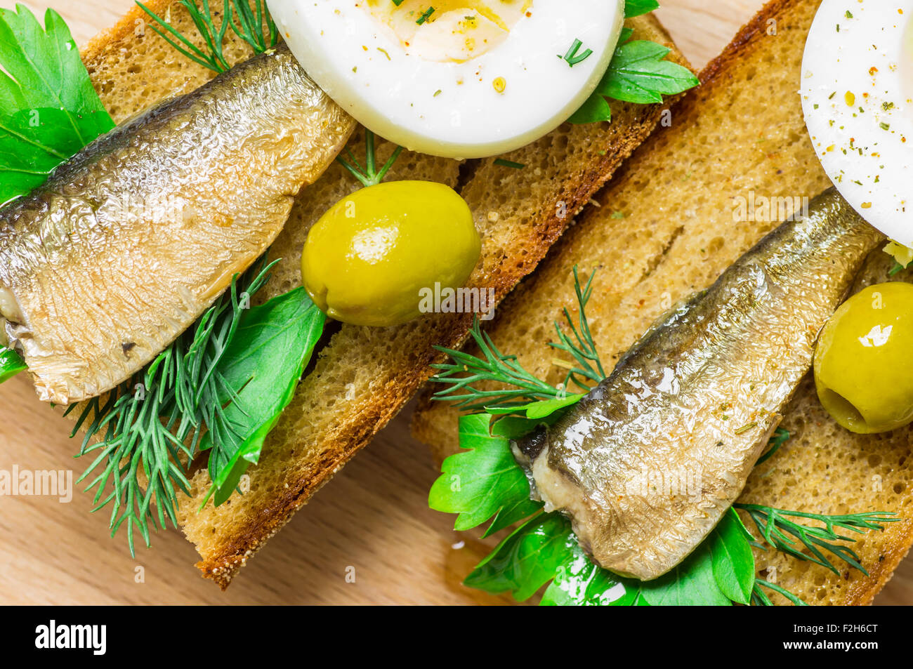 Sardines on toasted bread with green olives Stock Photo Alamy