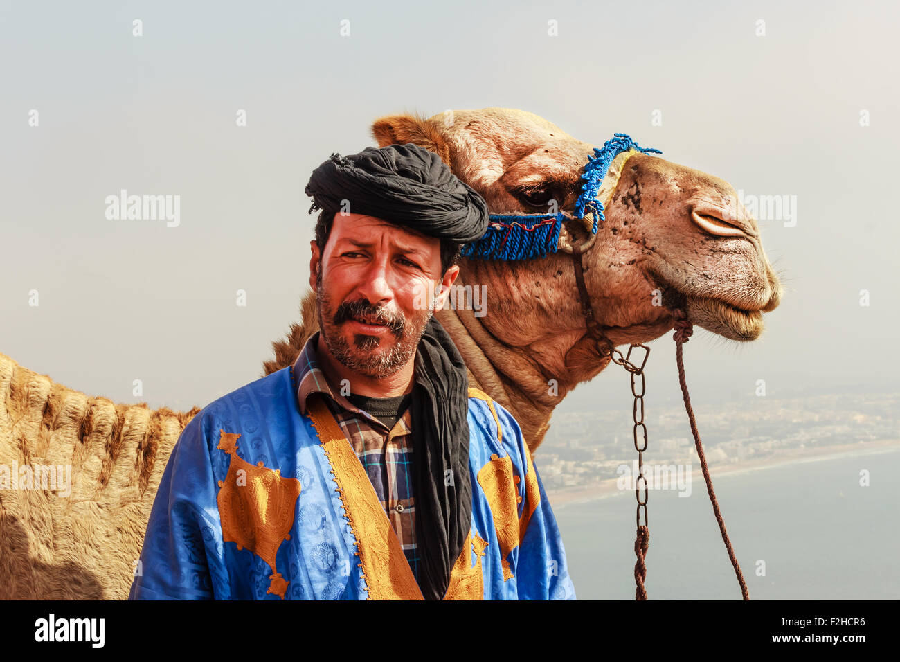 Camel driver with his camel Stock Photo
